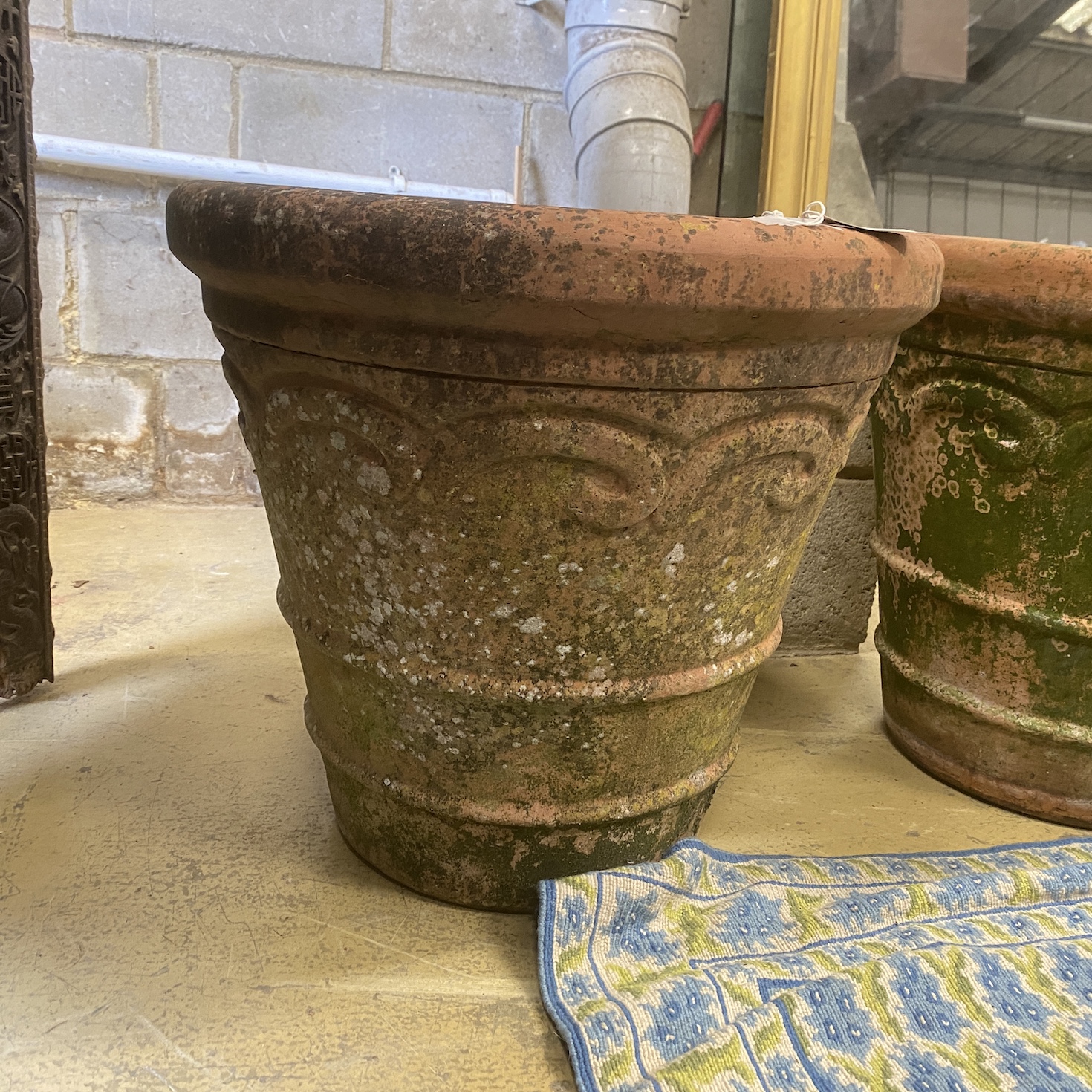 A pair of circular weathered terracotta garden planters, diameter 54cm, height 51cm